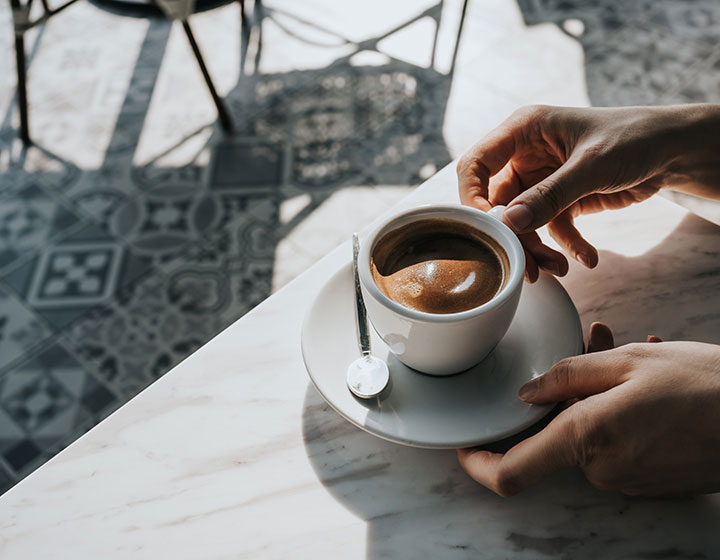person holding coffee cup